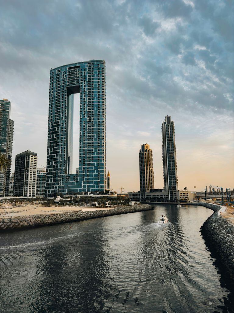 Stunning cityscape of Dubai's architectural designs along the canal during twilight.