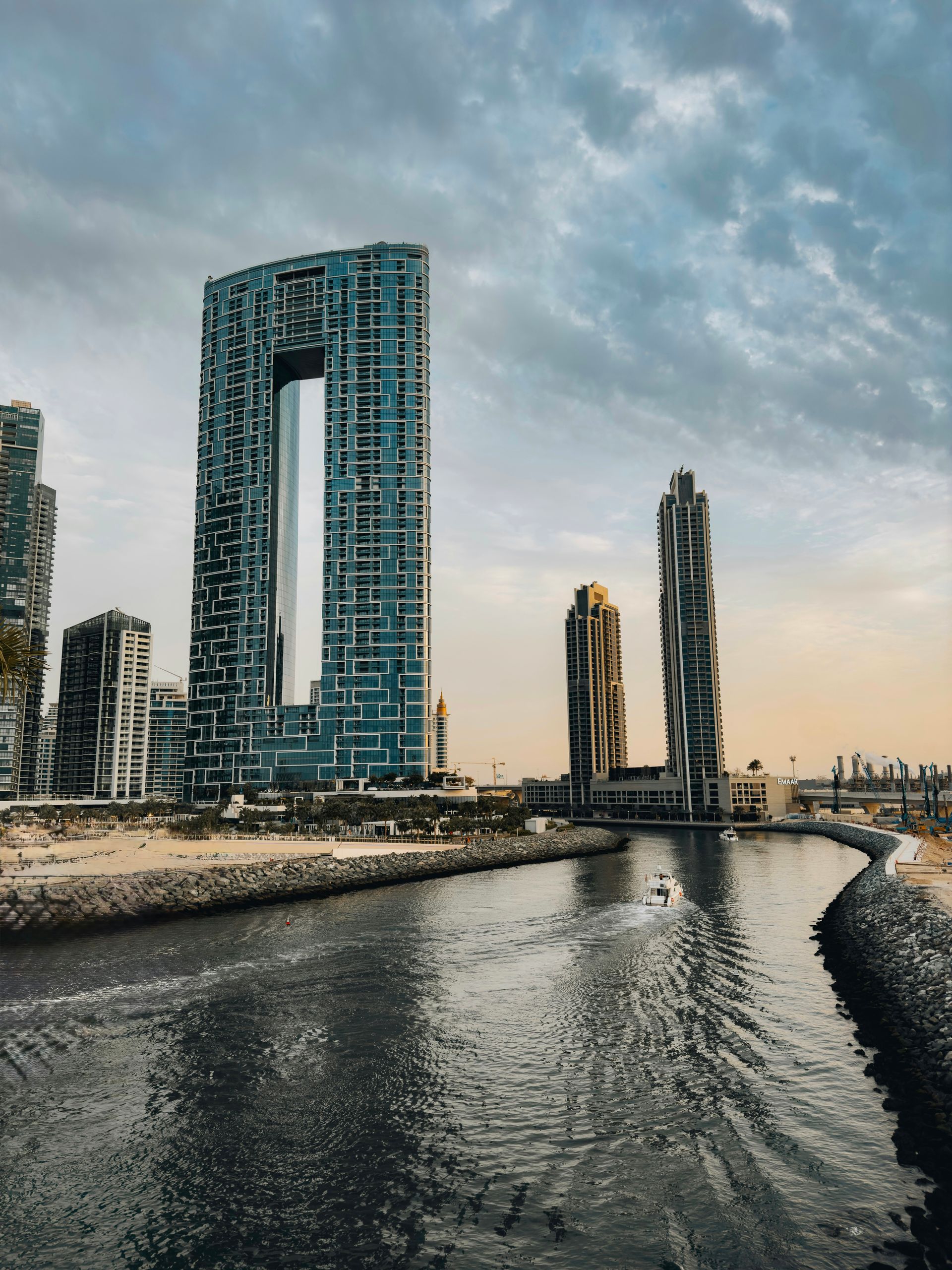 Stunning cityscape of Dubai's architectural designs along the canal during twilight.